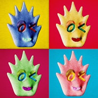 a set of four colorful squares with a kooky face on them